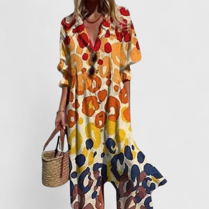 Multicolor abstract print boho dress with V-neck and button front, elbow sleeves.