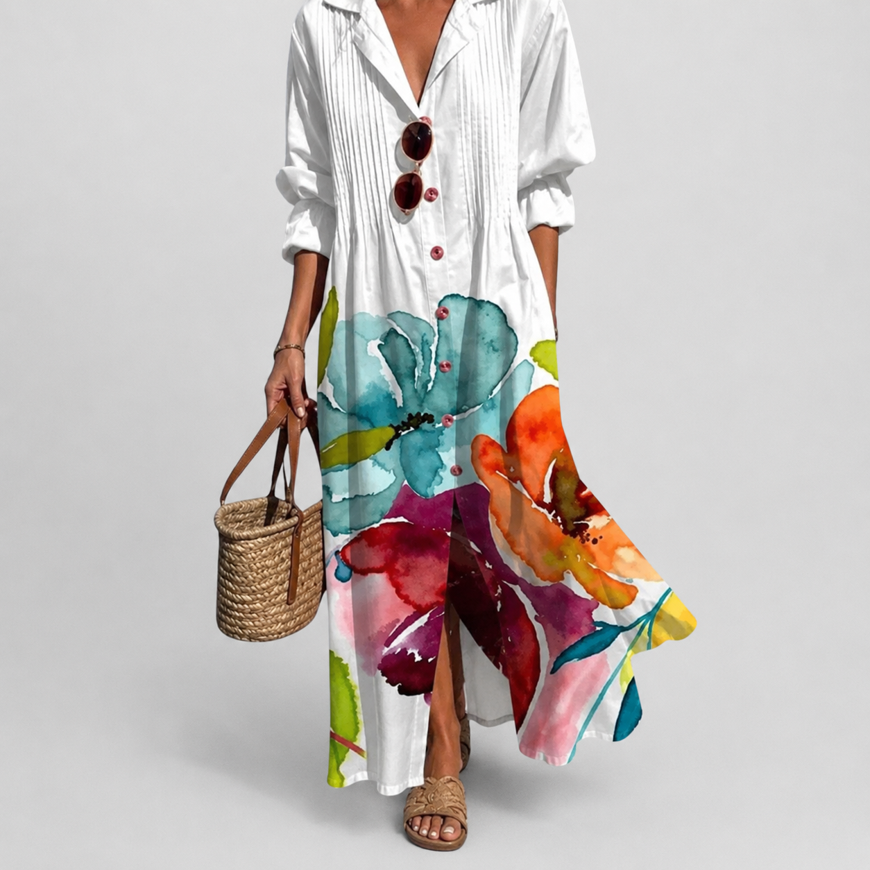 White boho dress with large watercolor floral print and V-neck button front, side slits.